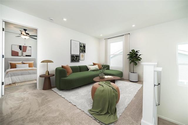 living room with carpet flooring, ceiling fan, and plenty of natural light