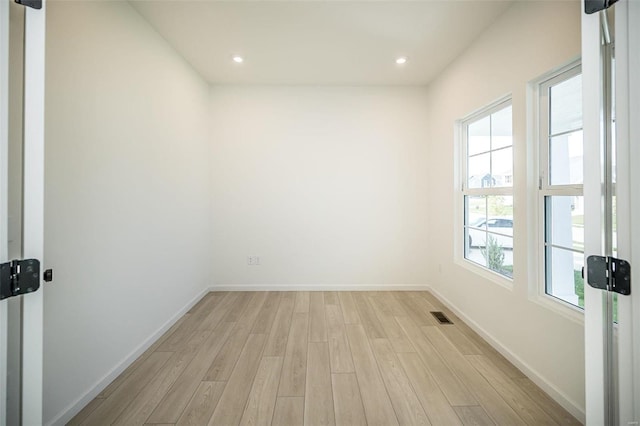 empty room with light hardwood / wood-style flooring