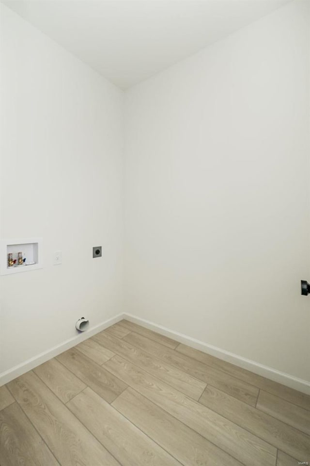 laundry room with electric dryer hookup, hookup for a washing machine, and light wood-type flooring