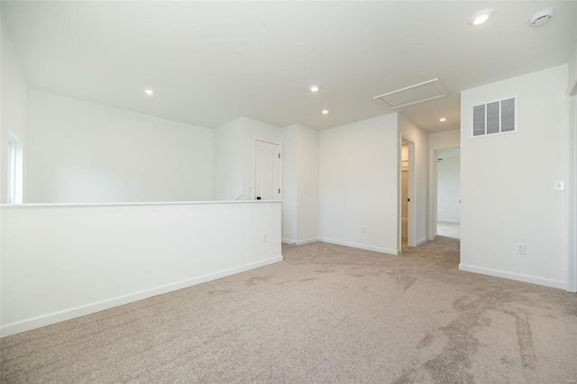 spare room featuring light colored carpet