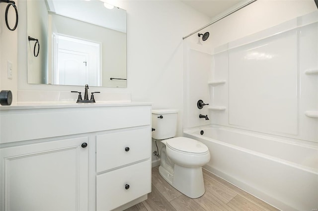 full bathroom featuring vanity, wood-type flooring,  shower combination, and toilet