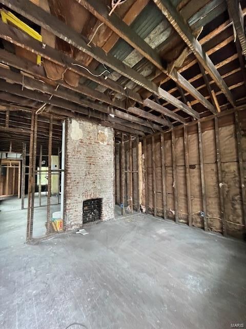 miscellaneous room featuring concrete flooring and a fireplace