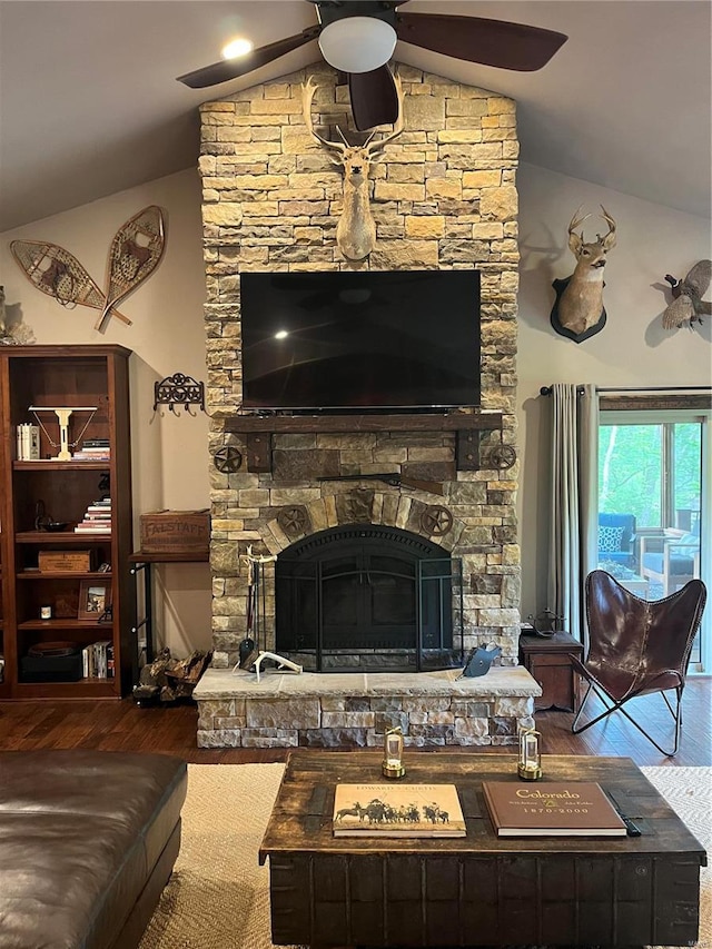 living room with a fireplace, hardwood / wood-style floors, ceiling fan, and lofted ceiling