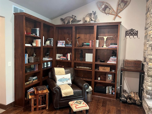 living area with dark hardwood / wood-style floors and lofted ceiling