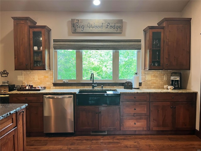 kitchen with plenty of natural light, dark hardwood / wood-style flooring, dishwasher, and light stone countertops