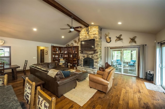 living room with a stone fireplace, ceiling fan, a healthy amount of sunlight, and hardwood / wood-style flooring