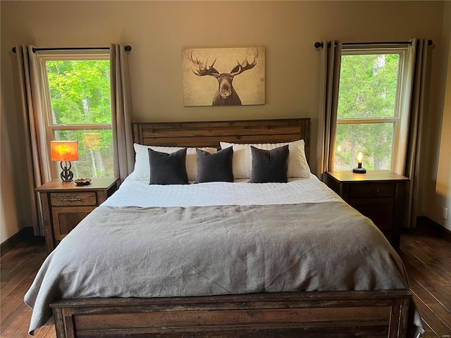 bedroom featuring dark wood-type flooring and multiple windows