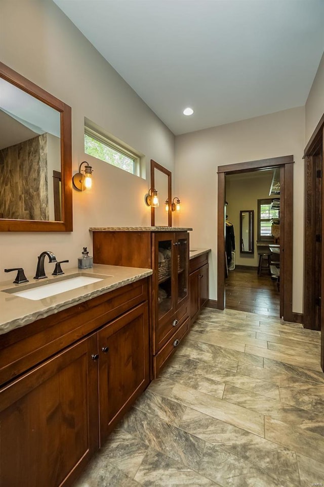 bathroom with a wealth of natural light, tile flooring, and vanity