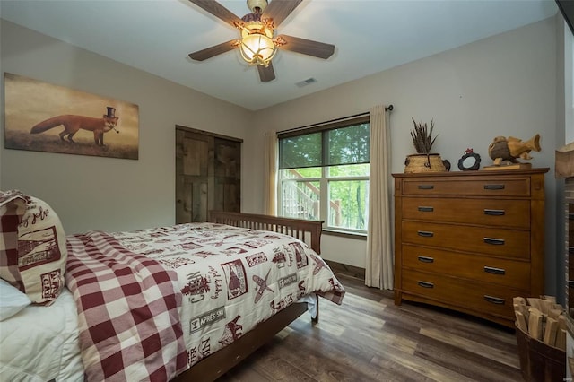 bedroom featuring ceiling fan and dark hardwood / wood-style floors