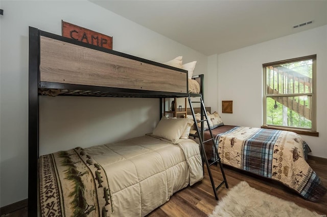 bedroom with dark hardwood / wood-style floors