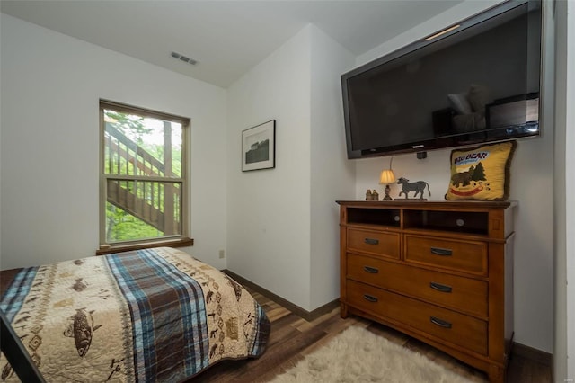 bedroom with wood-type flooring