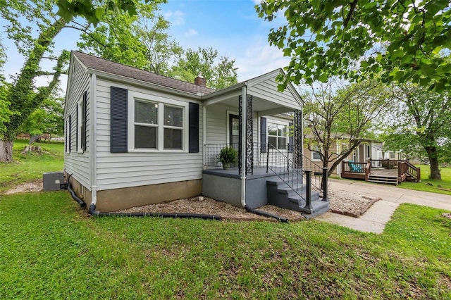 view of front facade with a front yard and a deck