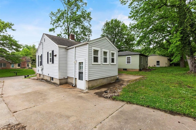 rear view of property featuring a yard