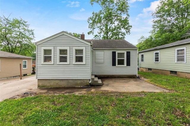 rear view of house with a yard