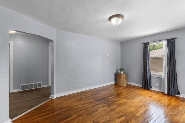 spare room featuring wood-type flooring