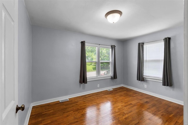 spare room with wood-type flooring