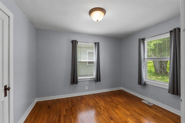 empty room featuring dark hardwood / wood-style flooring