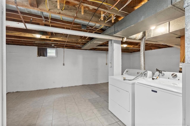 laundry room featuring light tile flooring and washer and dryer