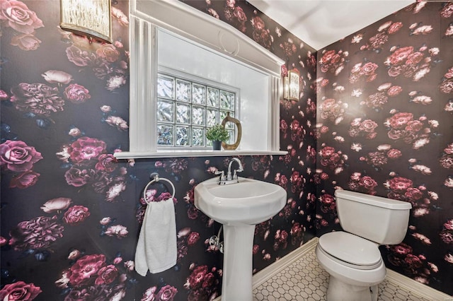 bathroom featuring toilet and tile patterned flooring