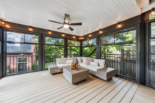 sunroom featuring ceiling fan