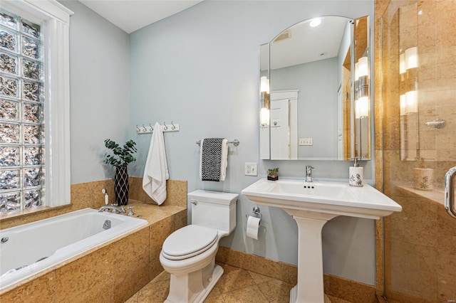 full bathroom with toilet, shower with separate bathtub, tile patterned floors, and sink