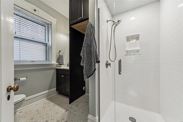 bathroom featuring toilet, vanity, an enclosed shower, and tile patterned flooring