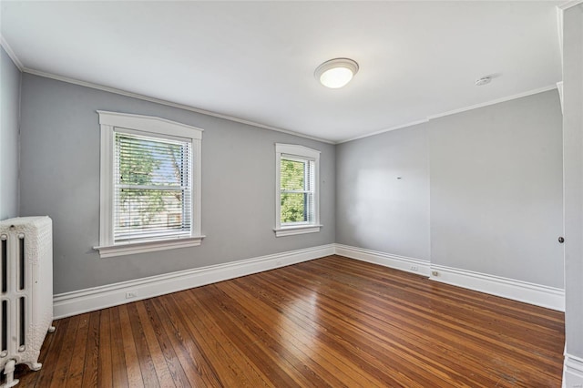 spare room featuring hardwood / wood-style flooring, a wealth of natural light, radiator, and ornamental molding