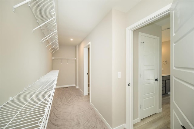 hallway featuring light carpet