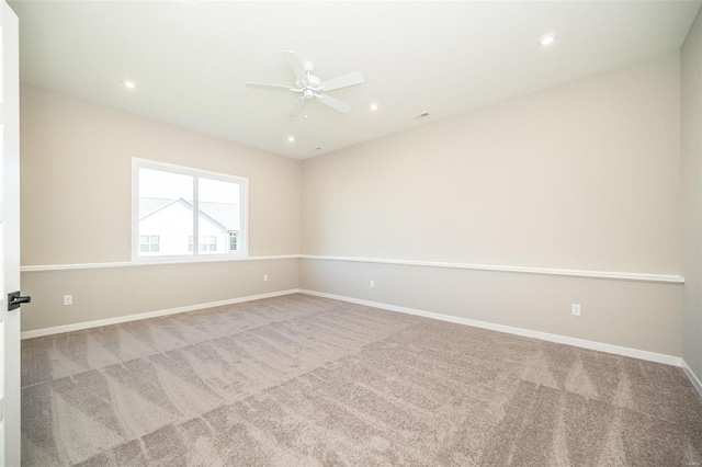 carpeted empty room featuring ceiling fan