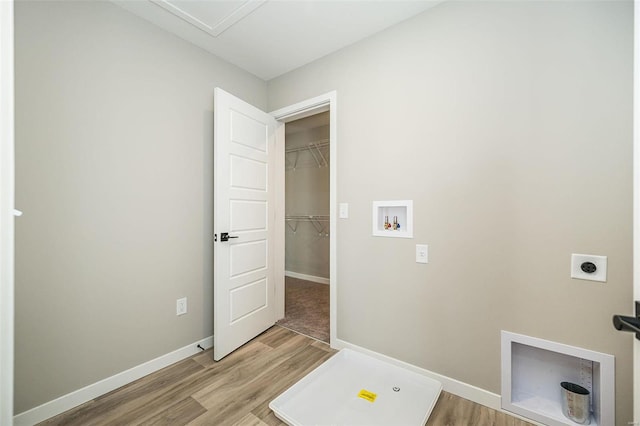 laundry room with hookup for a washing machine, light wood-type flooring, and hookup for an electric dryer