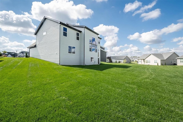 back of house featuring a lawn