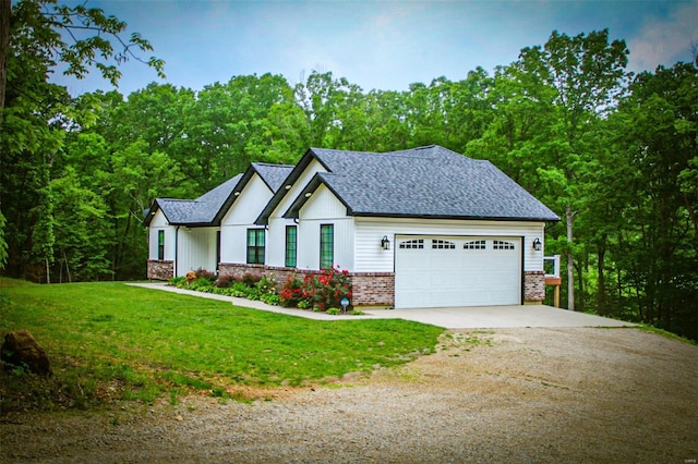 view of front of house featuring a garage and a front lawn