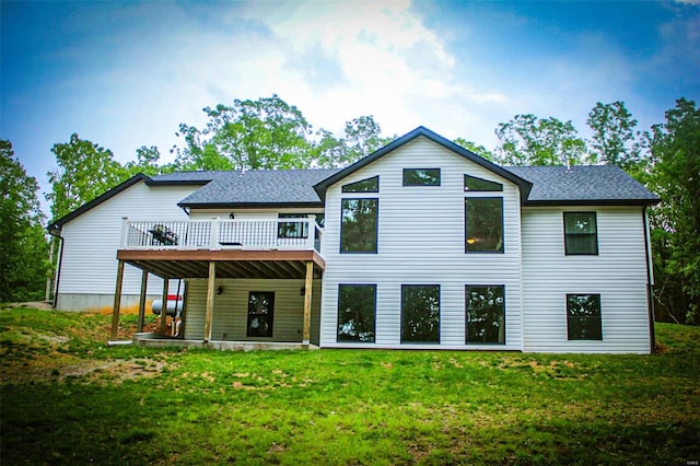 back of house with a lawn and a deck