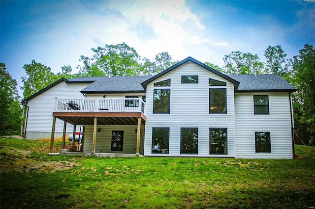 rear view of property with a wooden deck and a yard