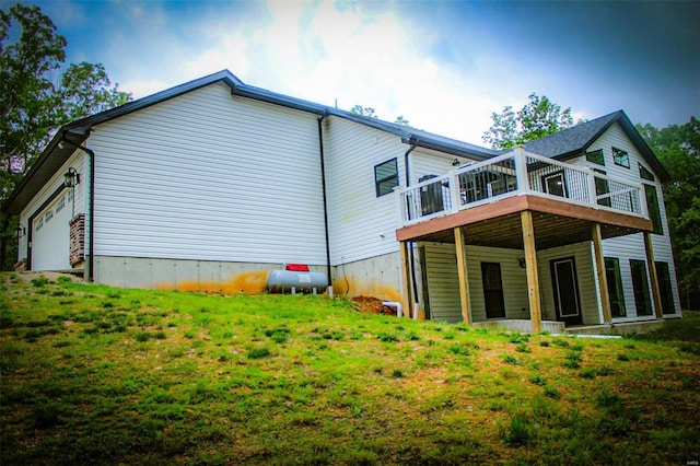 rear view of property featuring a lawn