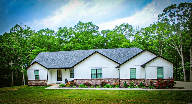 modern farmhouse style home with a front lawn