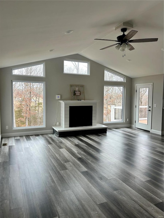 unfurnished living room with vaulted ceiling, hardwood / wood-style floors, ceiling fan, and a fireplace