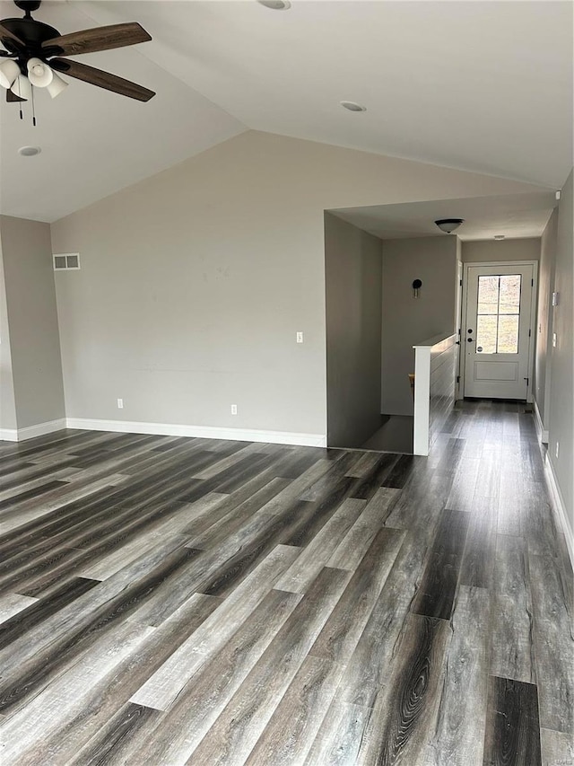 unfurnished living room featuring dark wood-type flooring, vaulted ceiling, and ceiling fan