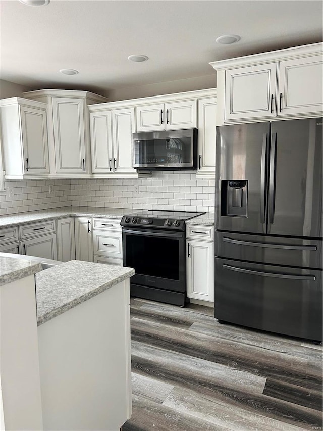 kitchen featuring backsplash, white cabinets, and appliances with stainless steel finishes