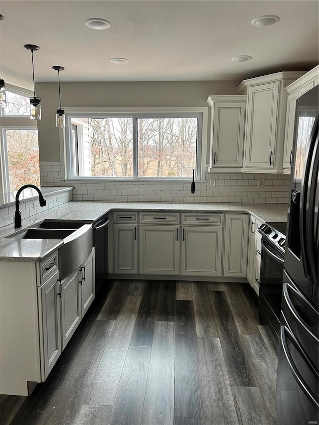 kitchen featuring white cabinetry, dark hardwood / wood-style flooring, light stone counters, and black appliances