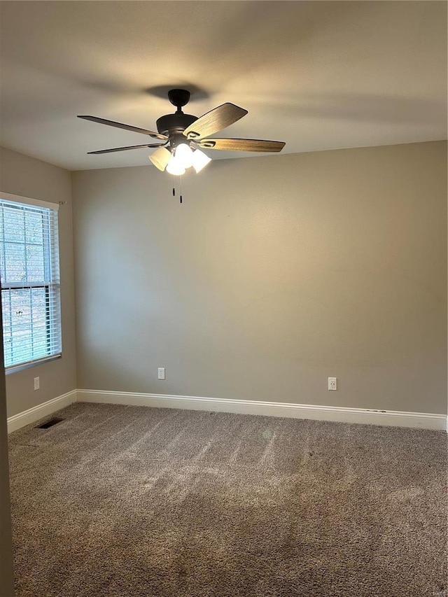 carpeted empty room featuring ceiling fan