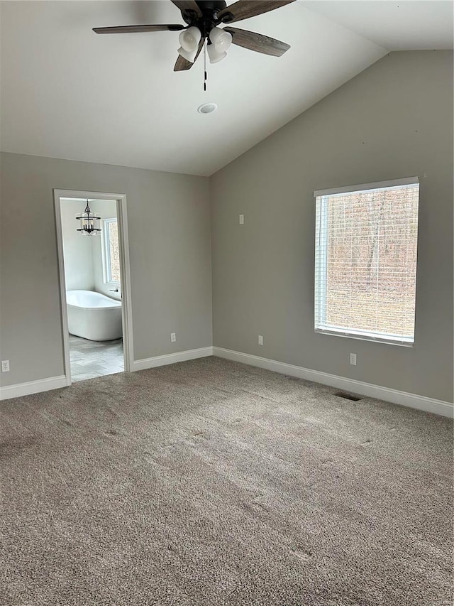 carpeted empty room featuring ceiling fan and lofted ceiling