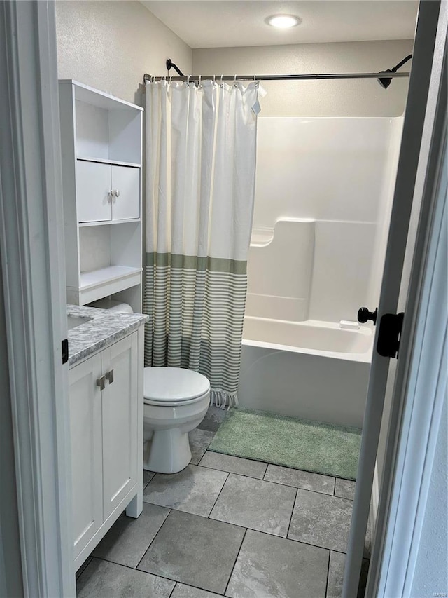 full bathroom featuring toilet, tile patterned floors, vanity, and shower / bathtub combination with curtain