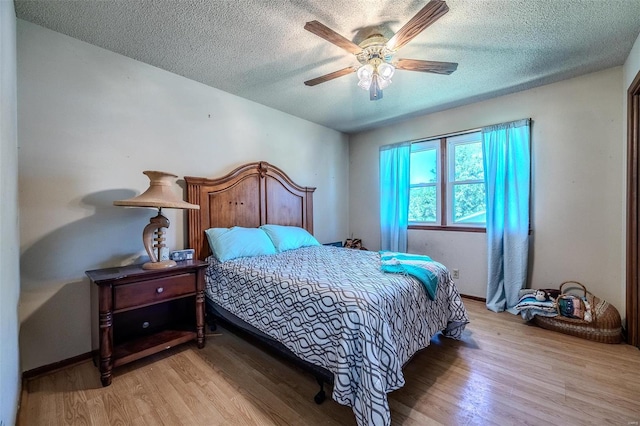 bedroom featuring a textured ceiling, light hardwood / wood-style floors, and ceiling fan