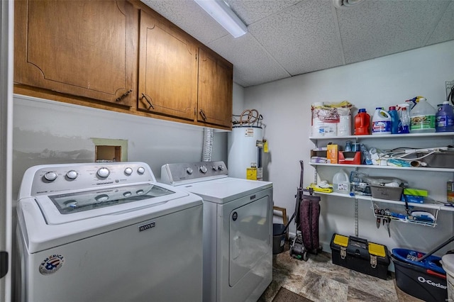 laundry room featuring separate washer and dryer, electric water heater, and cabinets