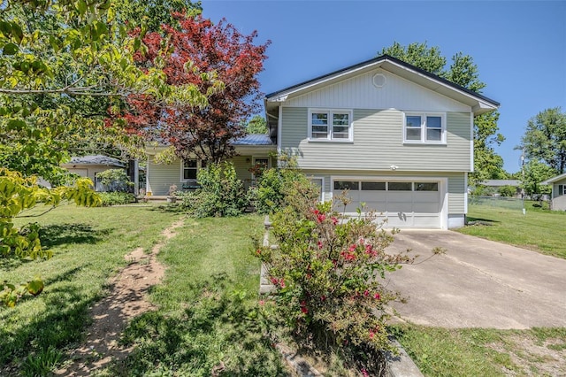 tri-level home featuring a garage, a front yard, and concrete driveway