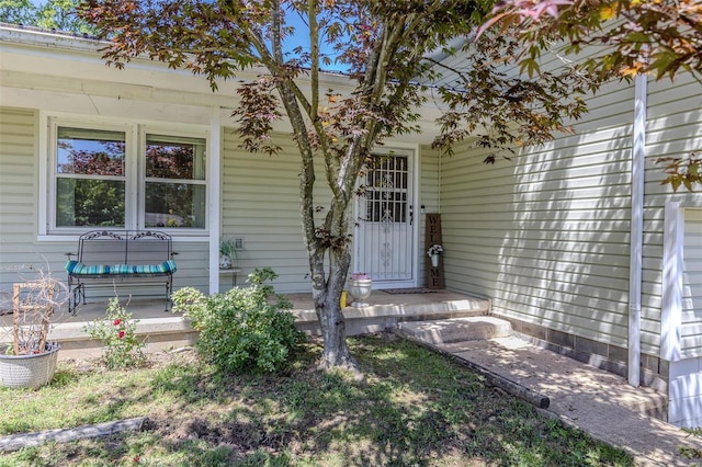 view of exterior entry with a porch