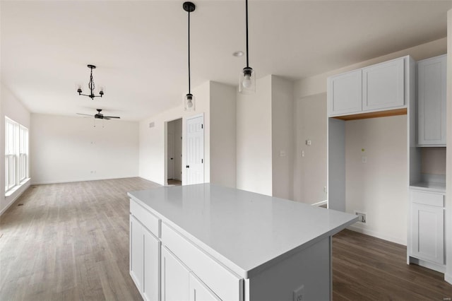 kitchen with white cabinets, dark hardwood / wood-style floors, pendant lighting, and ceiling fan