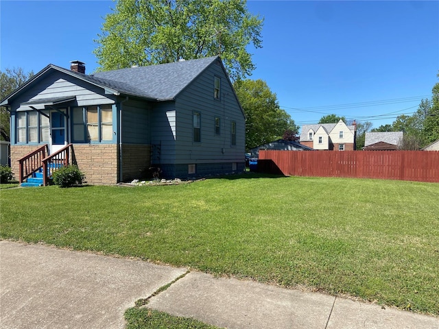 view of side of home featuring a lawn