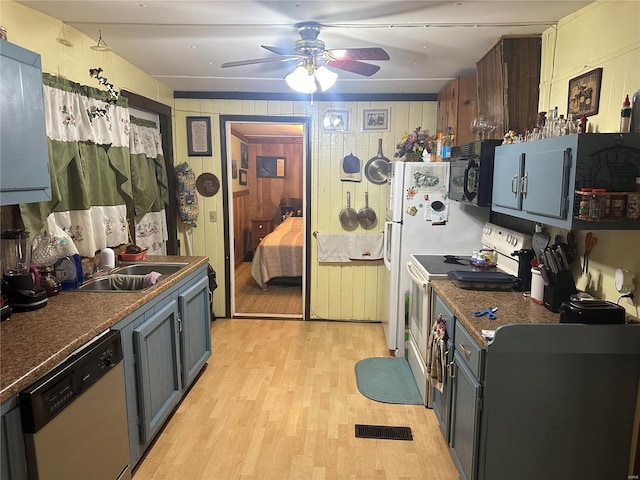 kitchen with ceiling fan, light wood-type flooring, white dishwasher, sink, and electric stove